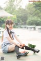 A woman sitting on a bench eating a watermelon.