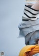 A close up of a person holding a yellow scarf.