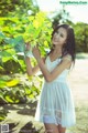 A woman in a white dress posing for a picture.